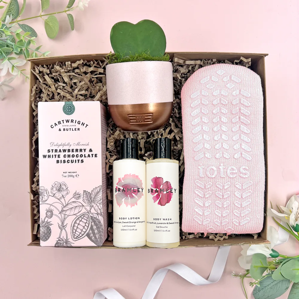 Calming care package gift box with cosy socks, Cowshed bath products, biscuits and heart shaped succulent
