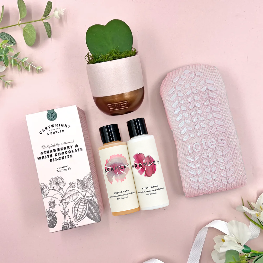Calming care package gift box with cosy socks, Cowshed bath products, biscuits and heart shaped succulent