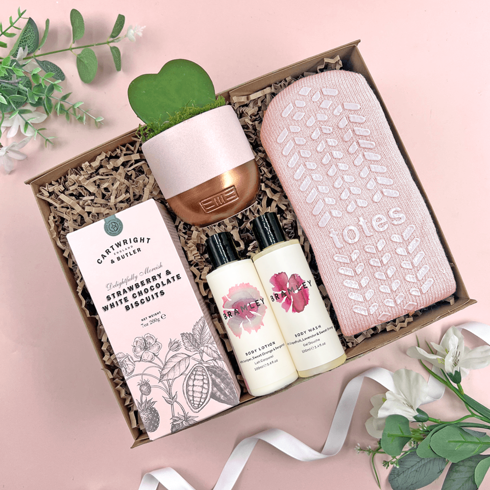 Calming care package gift box with cosy socks, Cowshed bath products, biscuits and heart shaped succulent