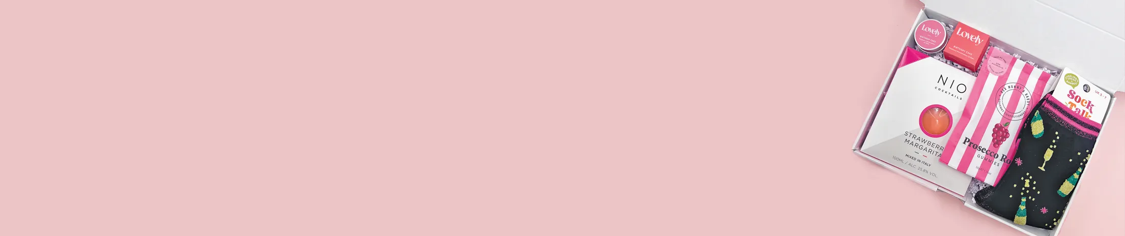 Letterbox gift hamper with cocktail, sweets, prosecco gummies and novelty socks”