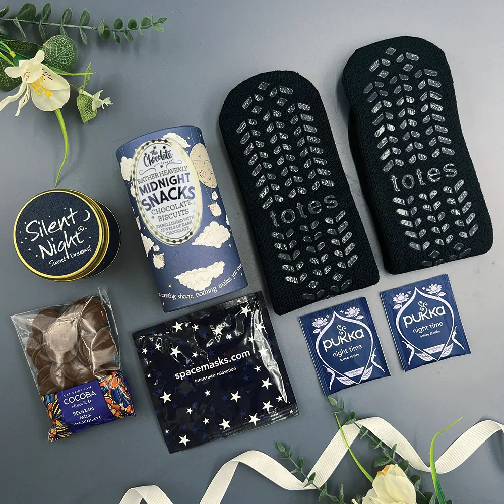 New baby boy gift hamper with dinosaur rattle and baby essentials