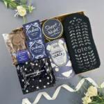 The New Mum Survival Kit for her featuring comforting treats, pamper items and thoughtful gifts designed to support and celebrate new mothers.