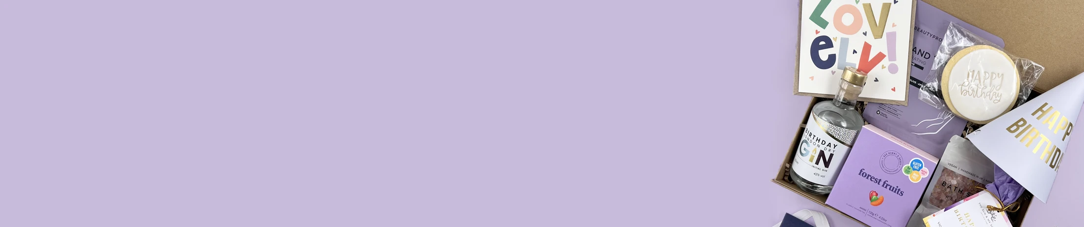 Unisex birthday gift hamper with sweets, drinks and fun items.