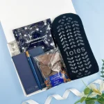 Relaxing letterbox gift hamper with cosy socks, chocolates, notebook and sleep mask