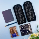 Relaxing letterbox gift hamper with cosy socks, chocolates, notebook and sleep mask