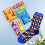 Men’s letterbox gift with colourful socks, popcorn, chocolate bars and sweets