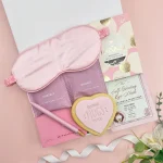 Pink letterbox gift hamper with tea, eye mask, chocolate and heart biscuit