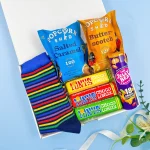 Men’s letterbox gift with colourful socks, popcorn, chocolate bars and sweets