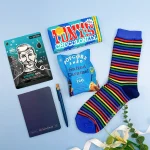 Letterbox gift for him featuring striped socks, popcorn, notebook and face mask