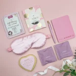 Pink letterbox gift hamper with tea, eye mask, chocolate and heart biscuit