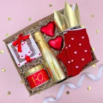 Elegant 40th birthday hamper for her featuring a gold crown, red heart chocolates, a golden sparkling drink bottle, chocolate gift box, and red heart-patterned socks in a decorative gift box.
