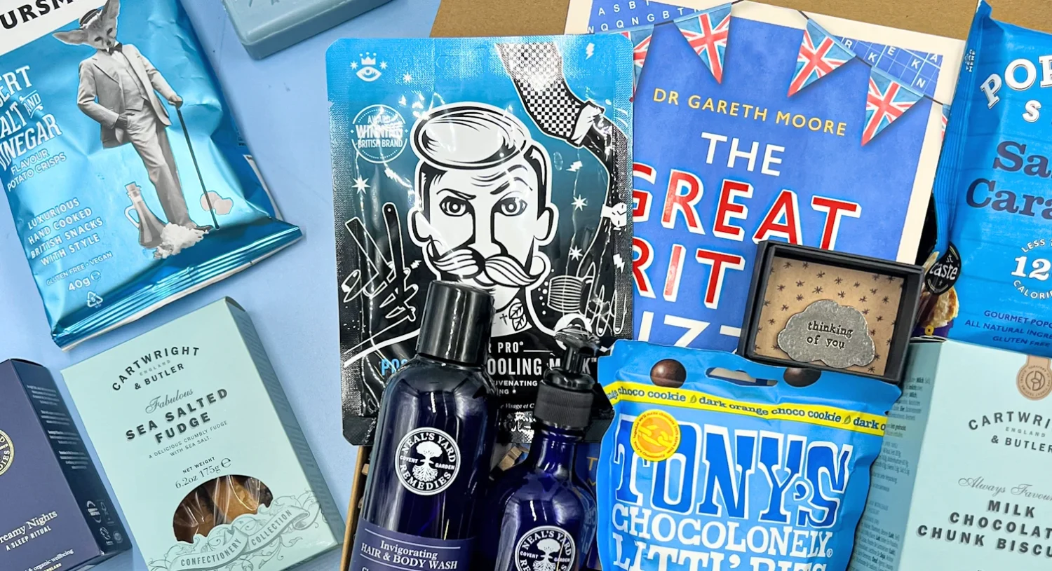 Cancer care package for him with snacks, self-care products, puzzle book, and thoughtful gifts in a hamper