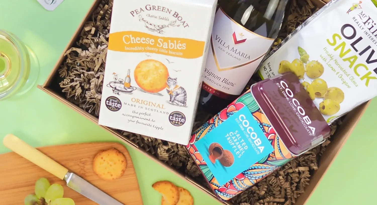 Foodie gift hamper with wine, cheese biscuits, olives and chocolate treat